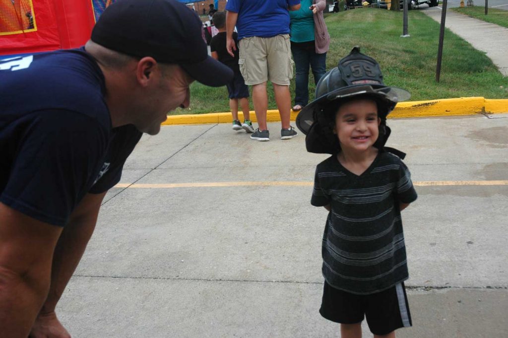 Future Firefighter trying the helmet on for size at the 2018 National Night Out.